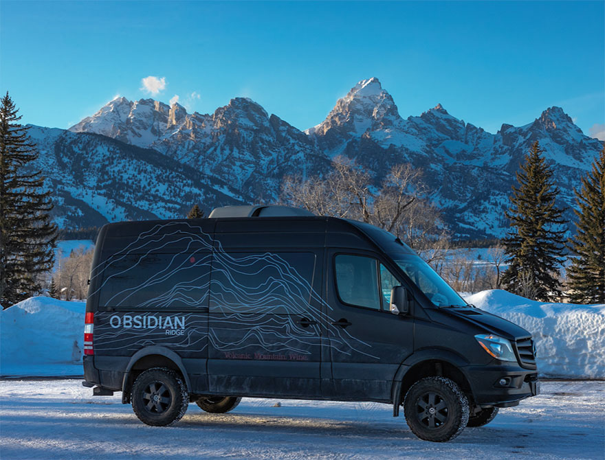 Obsidian branded van exterior with mountains in the background.